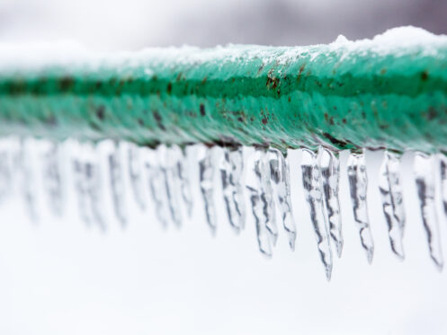 Frozen pipe with icicles dripping down